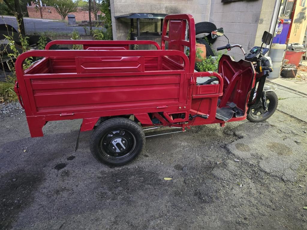 Red 2026 ET13 electric utility tricycle, rear-side view